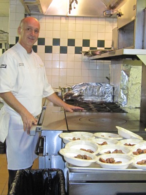 Sous Chef Leonard Reese shows off the French Plaque stoves in the Aquarelle kitchen.